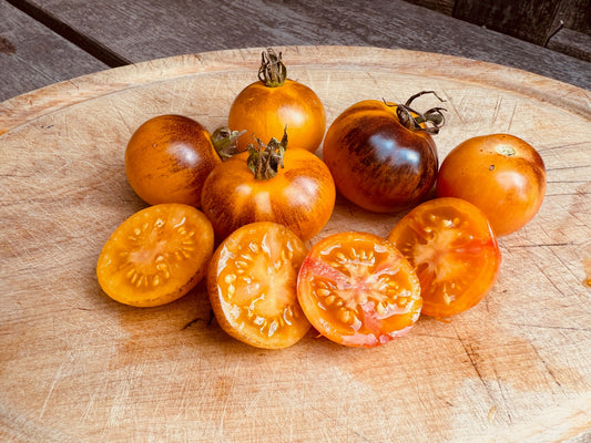 Assorted cherry tomatoes on a wooden cutting board