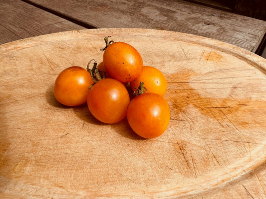 Tomatoes on a wooden cutting board