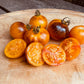 Assorted cherry tomatoes on a wooden cutting board