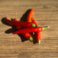 Red chili peppers on a wooden surface